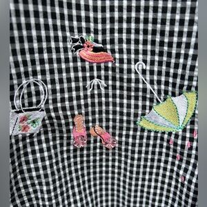 Short sleeve, button up, black-and-white checkered pattern and embellishments